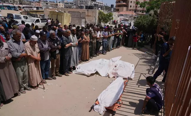 Palestinians pray during the funeral of a person who was killed while heading to a Gaza aid hub, along with three others who were killed during an Israeli strike, as they gather at the Nasser Hospital in Khan Younis, southern Gaza Strip, Sunday, June 1, 2025. (AP Photo/Abdel Kareem Hana)