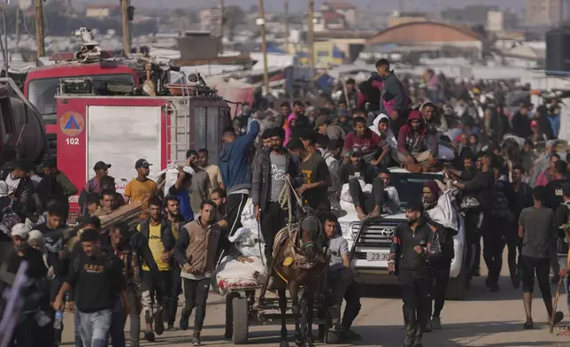 Palestinians carry boxes and bags containing food and humanitarian aid packages delivered by the Gaza Humanitarian Foundation, a U.S.-backed organization approved by Israel, in Khan Younis, southern Gaza Strip, Sunday, June 1, 2025. (AP Photo/Abdel Kareem Hana)