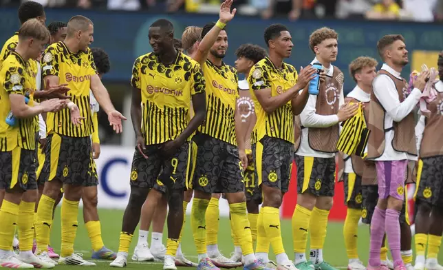 Players of Borussia Dortmund stand on the pitch at the end of the Club World Cup group F soccer match between Fluminense and Borussia Dortmund in East Rutherford, N.J., Tuesday, June 17, 2025. (AP Photo/Frank Franklin II)
