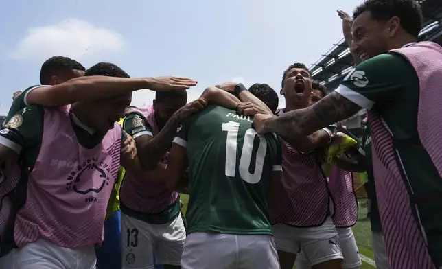 Teammates react with Palmeiras' Paulinho after a goal during the Club World Cup round of 16 soccer match between Palmeiras and Botafogo in Philadelphia, Saturday, June 28, 2025. (AP Photo/Matt Slocum)