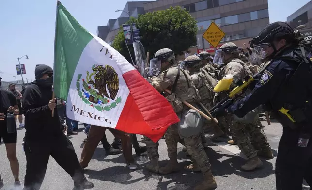 FILE - Protesters clash with authorities in downtown Los Angeles, Sunday, June 8, 2025, following last night's immigration raid protest. (AP Photo/Jae Hong, File)