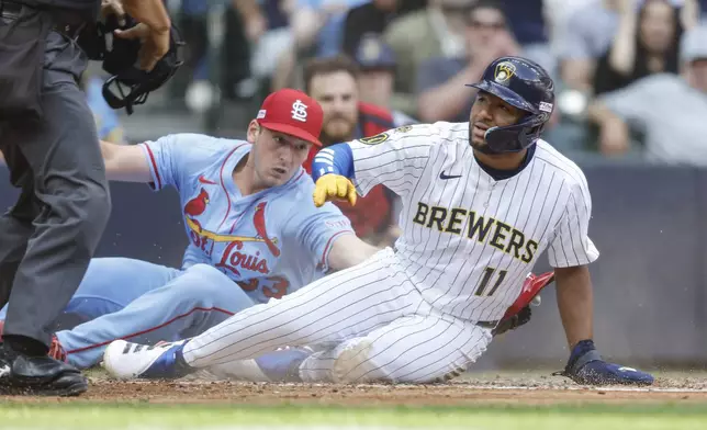 Milwaukee Brewers' Jackson Chourio (11) scores ahead of the tag by St. Louis Cardinals pitcher Andre Pallante during the fourth inning of a baseball game, Saturday, June, 14, 2025, in Milwaukee. (AP Photo/Jeffrey Phelps)