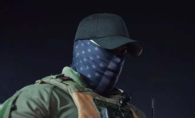 An Immigration and Customs Enforcement agent stands outside the Delaney Hall Detention Facility during protests over federal immigration enforcement raids on Thursday, June 12, 2025, in Newark, N.J. (AP Photo/Olga Fedorova)