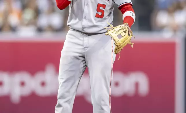 Washington Nationals' CJ Abrams reacts after trying to field a ground ball that hit his face in the fourth inning of a baseball game against the San Diego Padres, Monday, June 23, 2025, in San Diego. (AP Photo/Tony Ding)