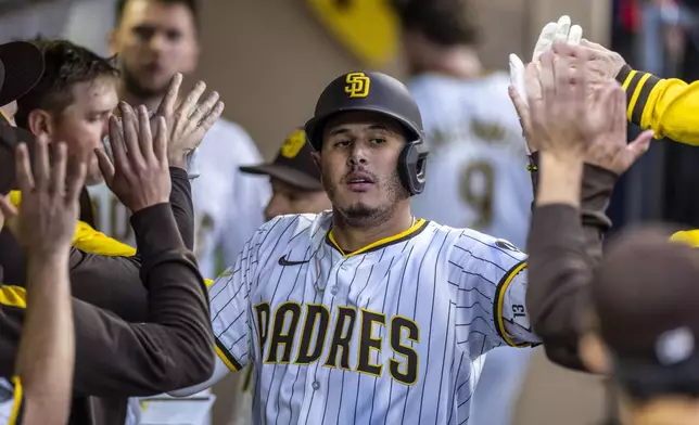 San Diego Padres' Manny Machado celebrates after his home run in the fourth inning of a baseball game against the Washington Nationals, Monday, June 23, 2025, in San Diego. (AP Photo/Tony Ding)