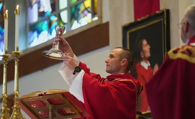 The Rev. Mike Sampson gives his first Mass at St. Charles Borromeo Catholic Church in Arlington, Va., on Sunday, June 8, 2025. (AP Photo/Jessie Wardarski)