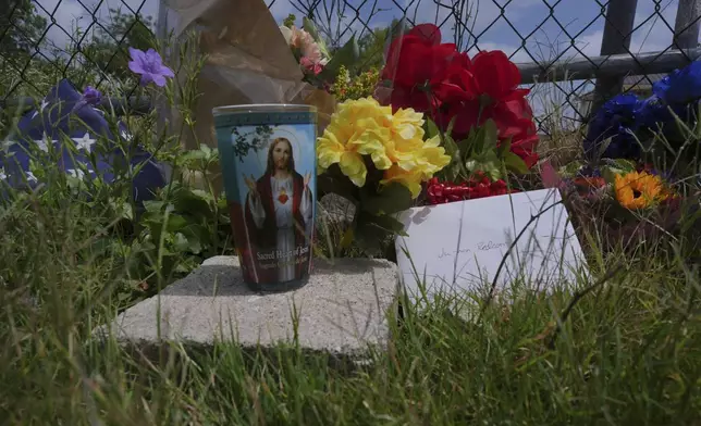 Candles, flowers, and notes make up make-shift memorial for voice actor Jonathan Joss who was recently killed, Tuesday, June 3, 2025, in San Antonio. (AP Photo/Eric Gay)