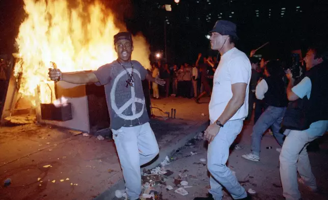 FILE - In this April 29, 1992 file photo, demonstrators protest the verdict in the Rodney King beating case in front of the Los Angeles Police Department headquarters in Los Angeles. (AP Photo/Nick Ut, File)
