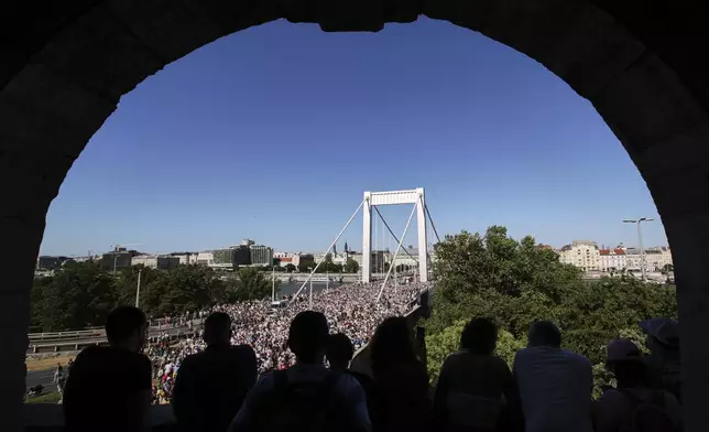Participants in the Pride march cross the Elisabeth Bridge in Budapest, Hungary, Saturday, June 28, 2025. (AP Photo/Rudolf Karancsi)