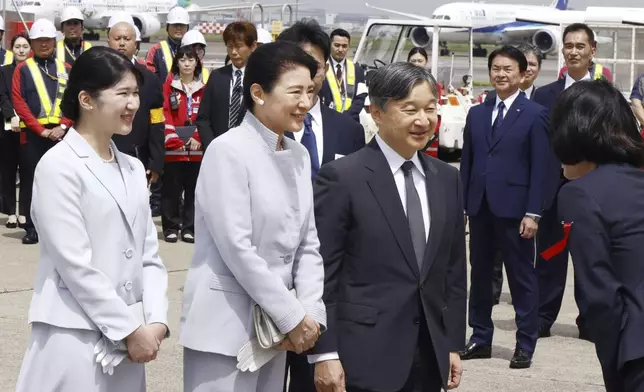 Japan's Emperor Naruhito, center right, accompanied by his wife, Empress Masako, center, and their daughter Princess Aiko, left, is greeted before their departure for Okinawa, at the Haneda airport in Tokyo, Wednesday, June 4, 2025.(Kyodo News via AP)