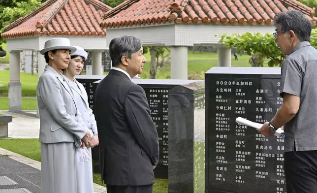 Japan's Emperor Naruhito, center, Empress Masako, left, and their daughter Princess Aiko, second left, stand in front of the Cornerstone of Peace monument walls on which the names of all those who lost their lives during the Battle of Okinawa, at the Peace Memorial Park in Itoman, Okinawa prefecture Wednesday, June 4, 2025. (Japan Pool/Kyodo News via AP)