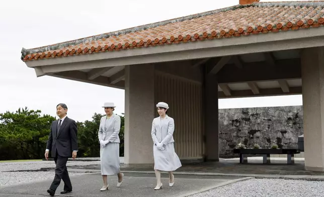 From left, Japan's Emperor Naruhito, Empress Masako and their daughter Princess Aiko leave after laying flowers before an ossuary at the National War Dead Peace Mausoleum in Itoman, Okinawa prefecture, southern Japan Wednesday, June 4, 2025. (Takumi Sato/Kyodo News via AP)