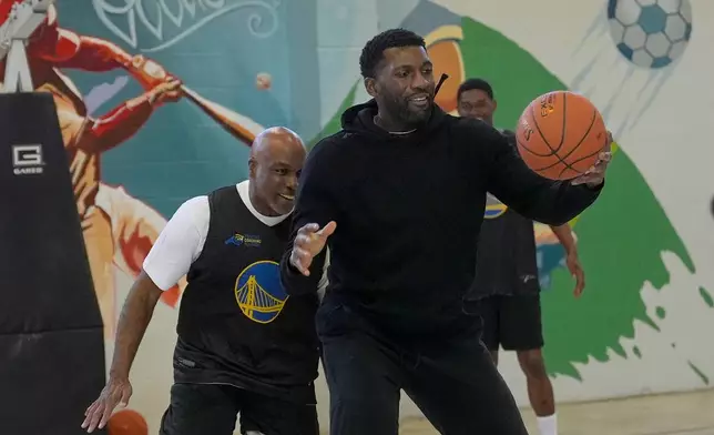Barry Monroe, left, guards former NBA basketball player Festus Ezeli as Twinning Project cohort 2 participants perform drills during the project's collaboration with the Golden State Warriors and the California Department of Corrections and Rehabilitation at Solano State Prison in Vacaville, Calif., Tuesday, Feb. 11, 2025. (AP Photo/Jeff Chiu)