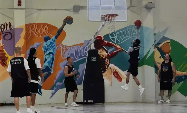 Twinning Project cohort 2 participants perform basketball drills during the project's collaboration with the Golden State Warriors and the California Department of Corrections and Rehabilitation at Solano State Prison in Vacaville, Calif., Tuesday, Feb. 11, 2025. (AP Photo/Jeff Chiu)