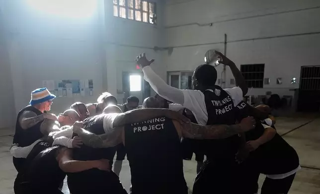 Twinning Project cohort 2 participants gather before performing drills during the project's collaboration with the NBA's Golden State Warriors and the California Department of Corrections and Rehabilitation at Solano State Prison in Vacaville, Calif., Tuesday, Feb. 11, 2025. (AP Photo/Jeff Chiu)