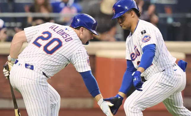 New York Mets' Juan Soto, right, celebrates with Pete Alonso after hitting a home run during the third inning of a baseball game against the Washington Nationals Tuesday, June 10, 2025, in New York. (AP Photo/Frank Franklin II)