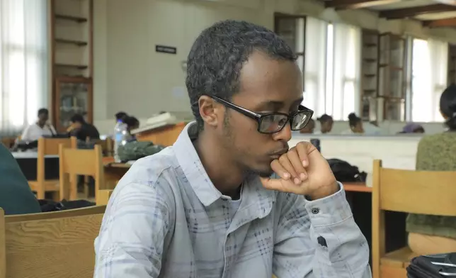 Yonas Nuguse, 21 years old, reads a book at Wemezeker National Library in Addis Ababa, Ethiopia Friday, May 30, 2025. (AP Photo/Amanuel Birhane)