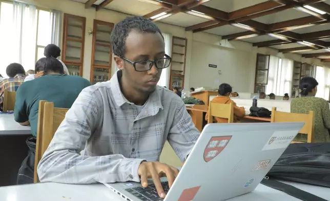 Yonas Nuguse, 21 years old, destined for Harvard University working on a computer at Wemezeker National Library in Addis Ababa, Ethiopia Friday, May 30, 2025. (AP Photo/Amanuel Birhane)