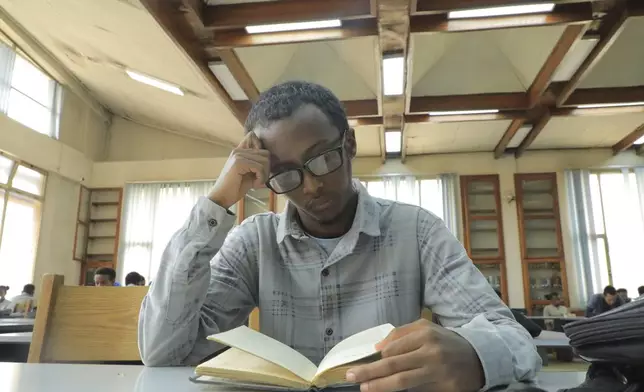 Yonas Nuguse, 21 years old, reads a book at Wemezeker National Library in Addis Ababa, Ethiopia Friday, May 30, 2025. (AP Photo/Amanuel Birhane)