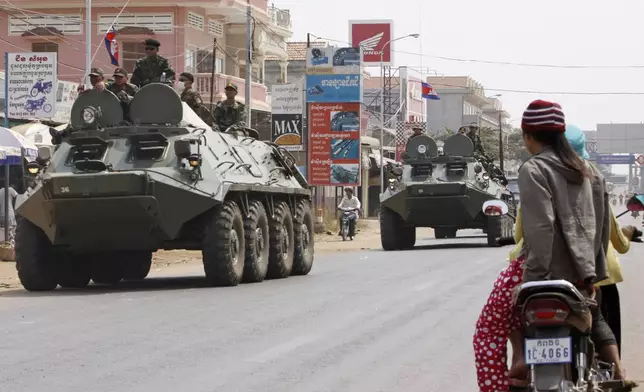 FILE- Armored personnel carriers of Cambodian Army drive through a road at Kampong Thom town, about 168 kilometers (104 mikes) north of Phnom Penh, Cambodia, Saturday, Feb. 12, 2011. (AP Photo/Heng Sinith, File)