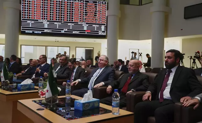 Syrian Finance Minister Mohammed Yisr Barnieh, center, attends the opening ceremony at the Damascus Securities Exchange in Damascus, Syria, Monday, June 2, 2025. (AP Photo/Omar Sanadiki)