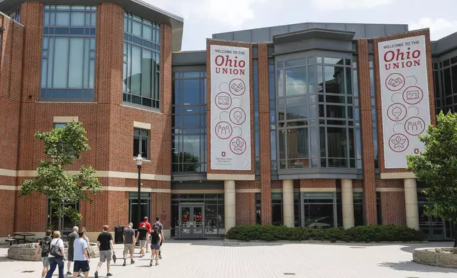 FILE -Pedestrians walk up to the The Ohio State University's student union, Saturday, May 18, 2019, in Columbus, Ohio. (AP Photo/John Minchillo, File)