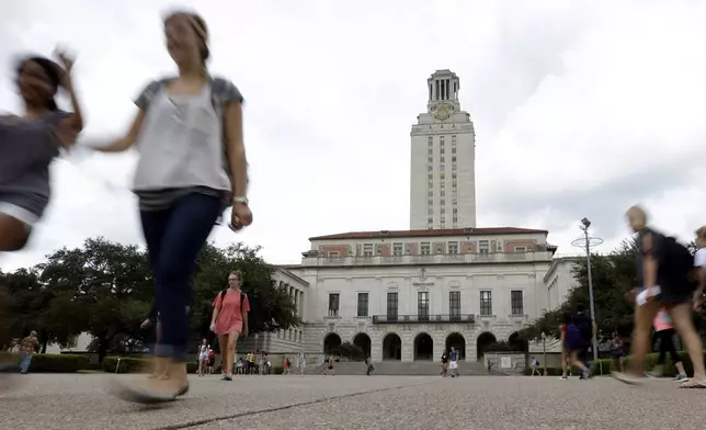 FILE - In this Sept. 27, 2012, file photo, students walk through the University of Texas at Austin campus near the school's iconic tower in Austin, Texas. (AP Photo/Eric Gay, File)