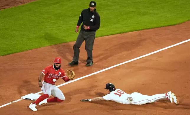 Boston Red Sox left fielder Jarren Duran beats a throw to Los Angeles Angels' Luis Rengifo on a steal after a wild pitch in the fifth inning of a baseball game Monday, June 2, 2025, in Boston. (AP Photo/Robert F. Bukaty)