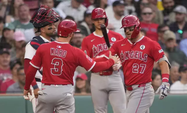 Los Angeles Angels designated hitter Mike Trout (27) is congratulated after a first inning home run in a baseball game against the Boston Red Sox, Monday, June 2, 2025, in Boston. (AP Photo/Robert F. Bukaty)