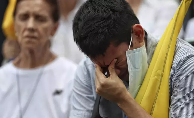 A man prays for Colombian Senator Miguel Uribe Turbay's recovery after he was shot at a political rally, in Cali, Colombia, Sunday, June 8, 2025. (AP Photo/Santiago Saldarriaga)