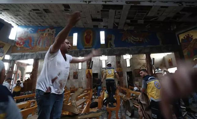 A Syrian man reacts inside Mar Elias church where a suicide bomber detonated himself in Dweil'a in the outskirts of Damascus, Syria, Sunday June 22, 2025. (AP Photo/Omar Sanadiki)