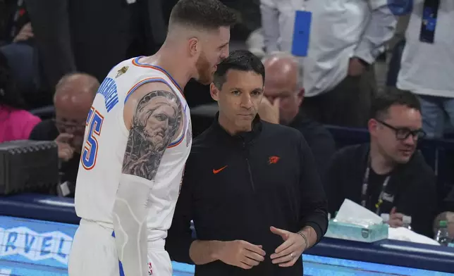 Oklahoma City Thunder center Isaiah Hartenstein (55) talks with head coach Mark Daigneault during the second half of Game 1 of the NBA Finals basketball series against the Indiana Pacers Thursday, June 5, 2025, in Oklahoma City. (AP Photo/Nate Billings)