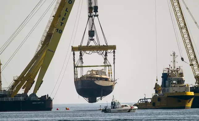 The hull of the superyacht Bayesian, which sank near Palermo, Sicily, on August 19, 2024, is pulled out of the sea off the village of Porticello to be taken to the nearby shipyard in Termini Imerese, Sunday, June 22, 2025. (AP Photo/Salvatore Cavalli)