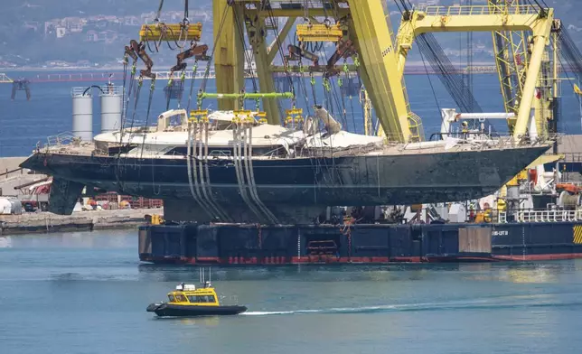 The hull of the superyacht Bayesian, which sank near Palermo, Sicily, on August 19, 2024, is taken to the shipyard in Termini Imerese, Italy, Sunday, June 22, 2025. (AP Photo/Salvatore Cavalli)