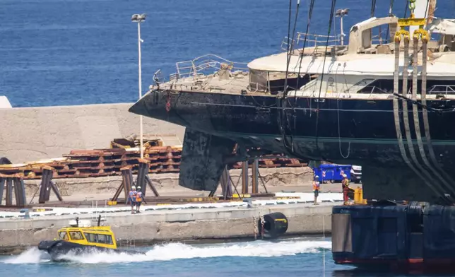 The hull of the superyacht Bayesian, which sank near Palermo, Sicily, on August 19, 2024, is taken to the shipyard in Termini Imerese, Italy, Sunday, June 22, 2025. (AP Photo/Salvatore Cavalli)