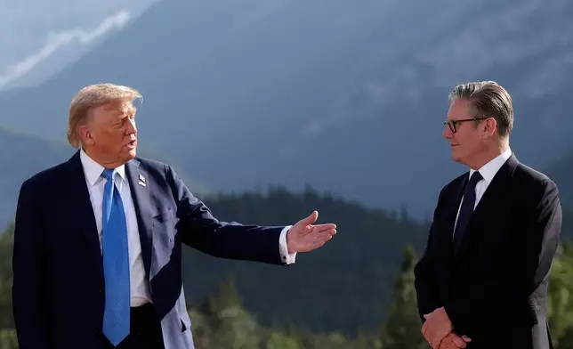 U.S. President Donald Trump, left, and Britain's Prime Minister Keir Starmer attend a family photo session during the G7 Summit, in Kananaskis, Alberta, Monday, June 16, 2025. (Suzanne Plunkett/Pool Photo via AP)