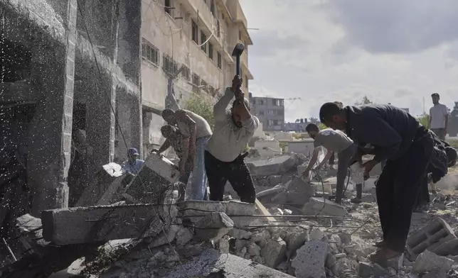 Palestinians try to clear the rubble of the Al-Ansar Mosque following an Israeli strike in Deir al-Balah, Gaza Strip, Monday, June 2, 2025. (AP Photo/Abdel Kareem Hana)