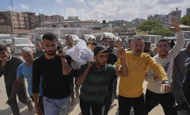 Palestinians carry the body of Hosam Wafi who, according to family members, was killed in an Israeli strike, during his funeral in Khan Younis, southern Gaza Strip, Monday, June 2, 2025. (AP Photo/Abdel Kareem Hana)