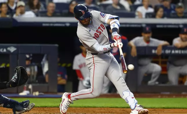 Boston Red Sox's Trevor Story hits a three run double against the New York Yankees during the third inning of a baseball game, Saturday, June 7, 2025, in New York. (AP Photo/Noah K. Murray)