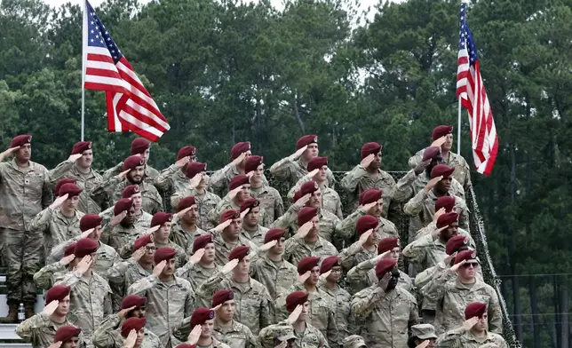 Soldiers of Fort Bragg stand in salute during the playing of the national anthem at The America 250 Celebration at Fort Bragg in Fayetteville, N.C., Tuesday, June 10, 2025. (AP Photo/Karl DeBlaker)
