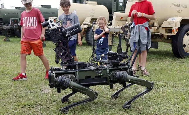 "Lone Wolf" a military robotic dog interacts with visitors at the America 250 Celebration at Fort Bragg in Fayetteville, N.C., Tuesday, June 10, 2025. (AP Photo/Karl DeBlaker)