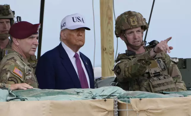 President Donald Trump observes rocket launches and other military demonstrations at Fort Bragg, Tuesday, June 10, 2025, in Fort Bragg, N.C. (AP Photo/Alex Brandon)