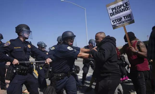 California Highway Patrol officers clash with protesters on Tuesday, June 10, 2025, in Los Angeles. (AP Photo/Eric Thayer)