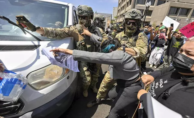 Police use pepper spray as they move protesters away from a van leaving the Federal Building in Santa Ana, Calif., on Monday, June 9, 2025. (Jeff Gritchen/The Orange County Register via AP)