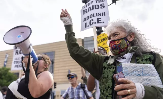 Demonstrators protest ongoing raids by Immigration and Customs Enforcement officers, Tuesday, June 10, 2025, in Washington. (AP Photo/Julia Demaree Nikhinson)