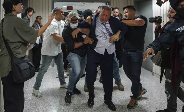 New York City Comptroller Brad Lander is placed under arrest by Immigration and Customs Enforcement (ICE) and FBI agents outside federal immigration court on Tuesday, June 17, 2025, in New York. (AP Photo/Olga Fedorova)