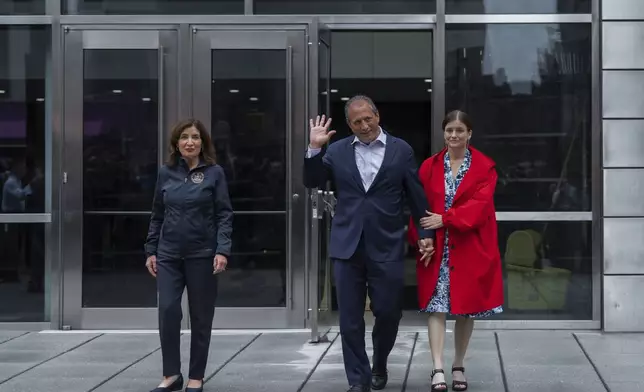New York City Comptroller Brad Lander, center, leaves Jacob K. Javits Federal Building with wife, Meg Barnette, right, and New York Gov. Kathy Hochul, left, after being released from arrest outside federal immigration court on Tuesday, June 17, 2025, in New York. (AP Photo/Olga Fedorova)
