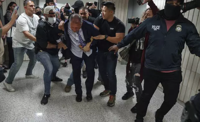 New York City Comptroller Brad Lander is placed under arrest by Immigration and Customs Enforcement (ICE) and FBI agents outside federal immigration court on Tuesday, June 17, 2025, in New York. (AP Photo/Olga Fedorova)