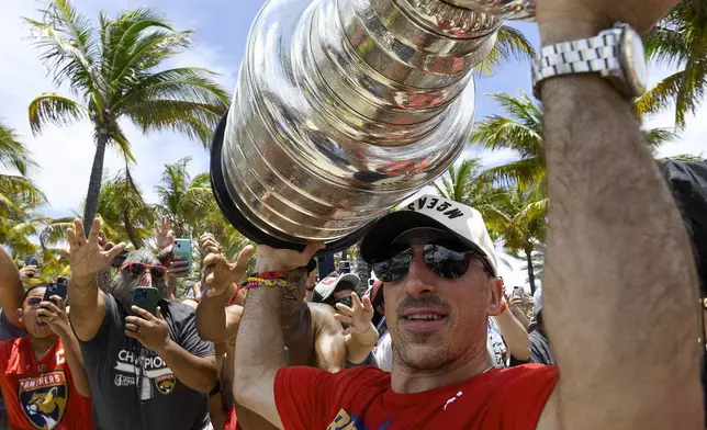 Florida Panthers Brad Marchand celebrates with fans during the NHL hockey team's Stanley Cup championship celebration, Sunday, June 22, 2025, in Fort Lauderdale, Fla (AP Photo/Michael Laughlin)