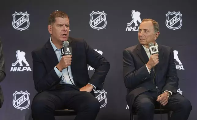 Marty Walsh, left, NHLPA Executive Director, and Gary Bettman, NHL Commissioner, conduct a joint press conference before the NHL hockey draft Friday, June 27, 2025, in Los Angeles. (AP Photo/Damian Dovarganes)